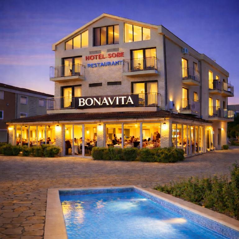a hotel with a swimming pool in front of it at Bonavita Zaton in Zaton
