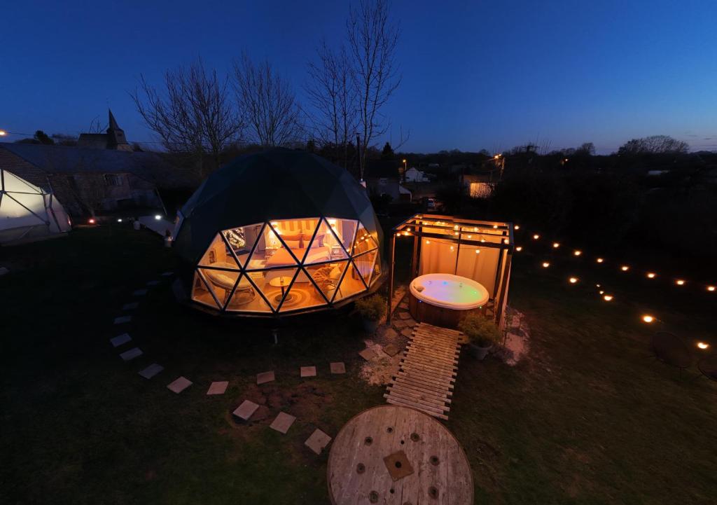 a couple of tents in the grass at night at Dôme Saint-Eloi in Floursies