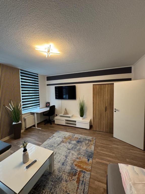a living room with a table and a desk at Ferienwohnung Florion 2 in Bernburg