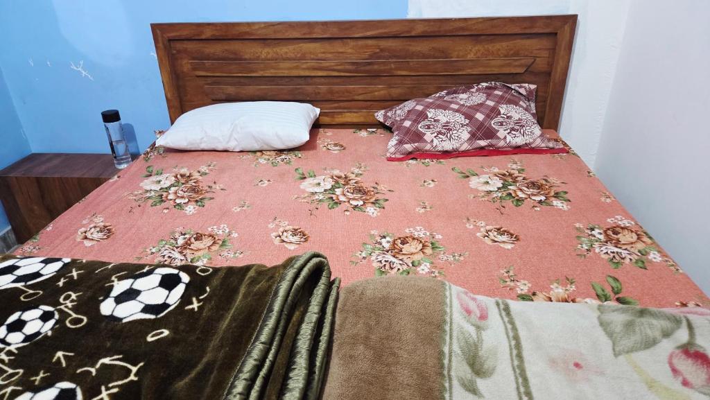 a bed with two pillows on top of it at Radha Rani Guest House in Sīkar