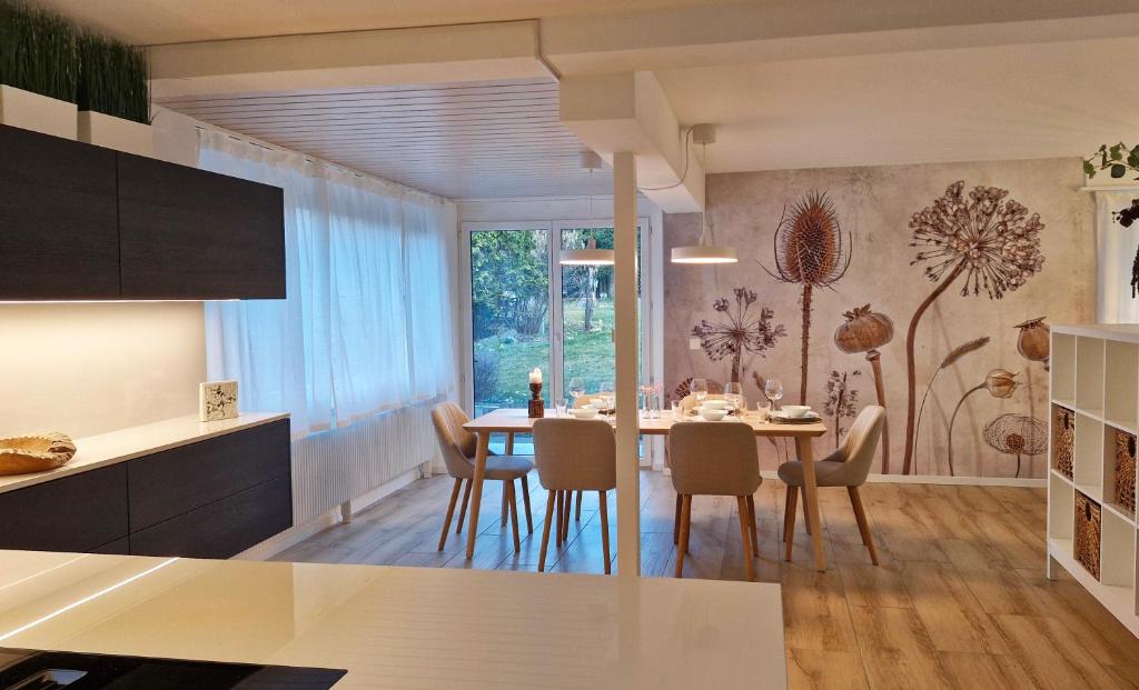 a kitchen and dining room with a table and chairs at Swiss Lakeside Apartments in Spiez