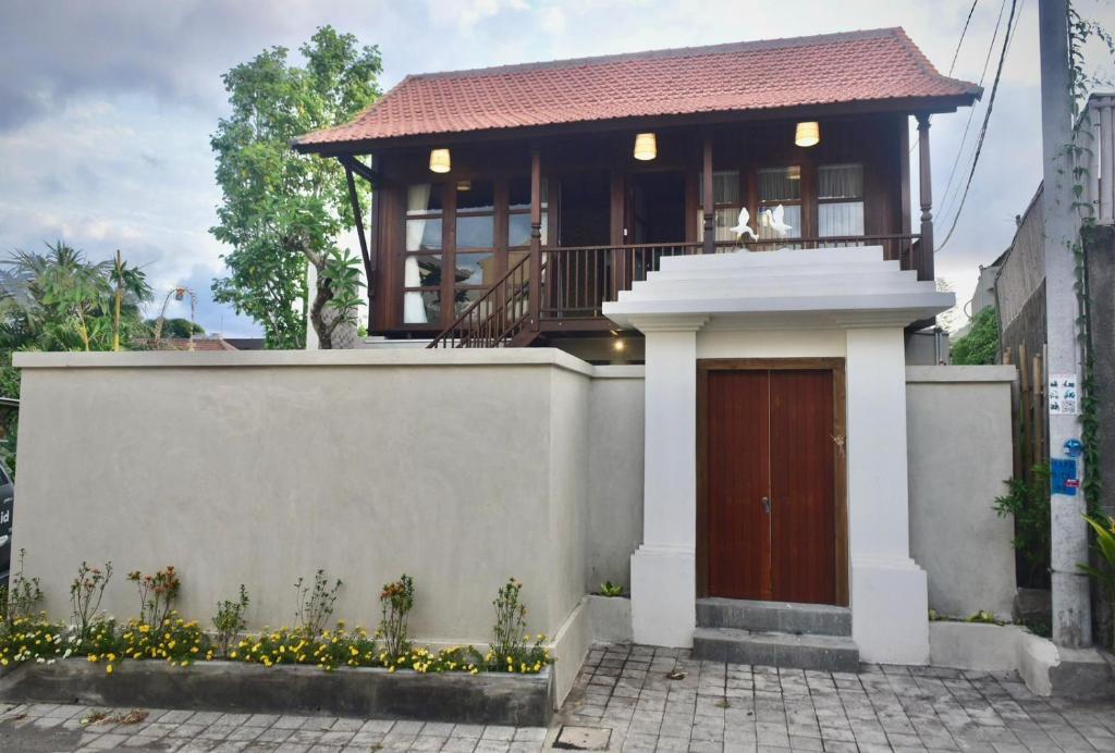 a small house with a balcony on top of it at Casa Loka in Canggu