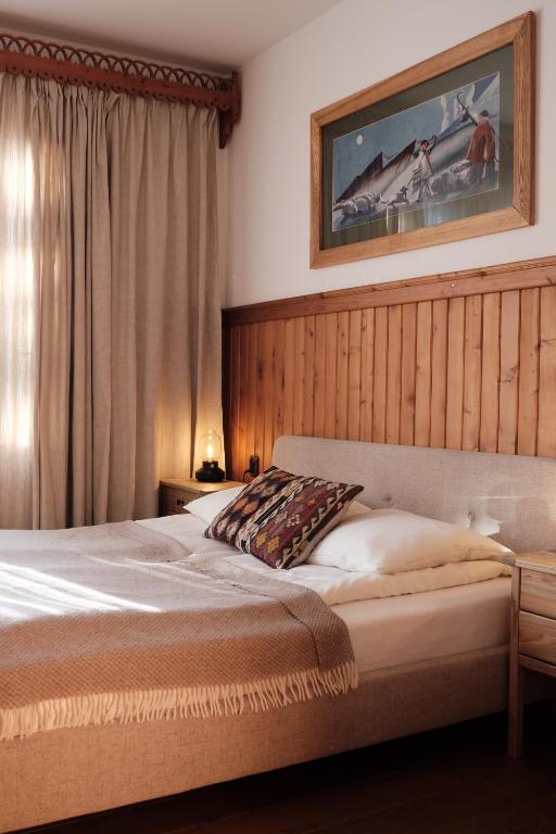 a bedroom with a bed and a picture on the wall at Willa Staszelówka in Zakopane