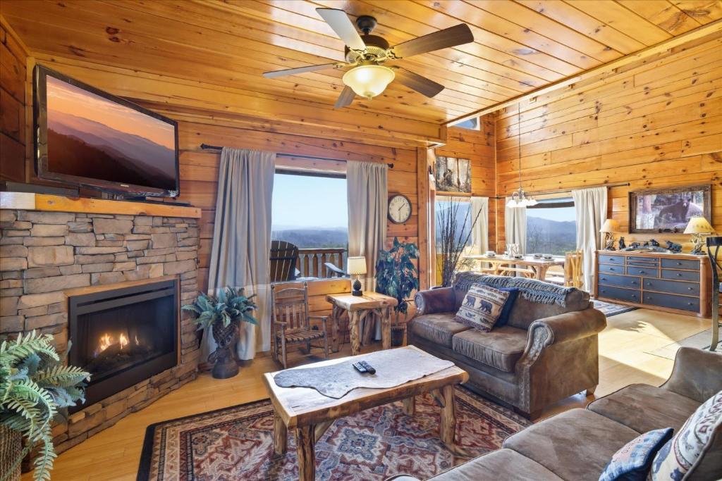 a living room with a couch and a fireplace at Smoky Mountain Bliss by Beyond Expectations in Sevierville