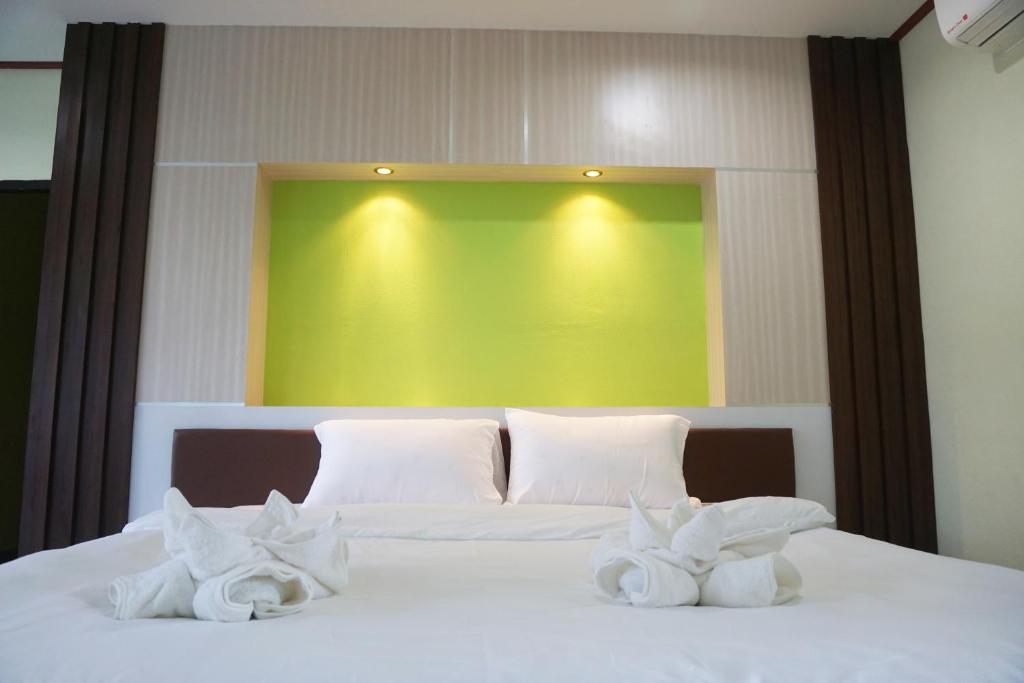 Postel nebo postele na pokoji v ubytování Honey Hotel Chiang Saen