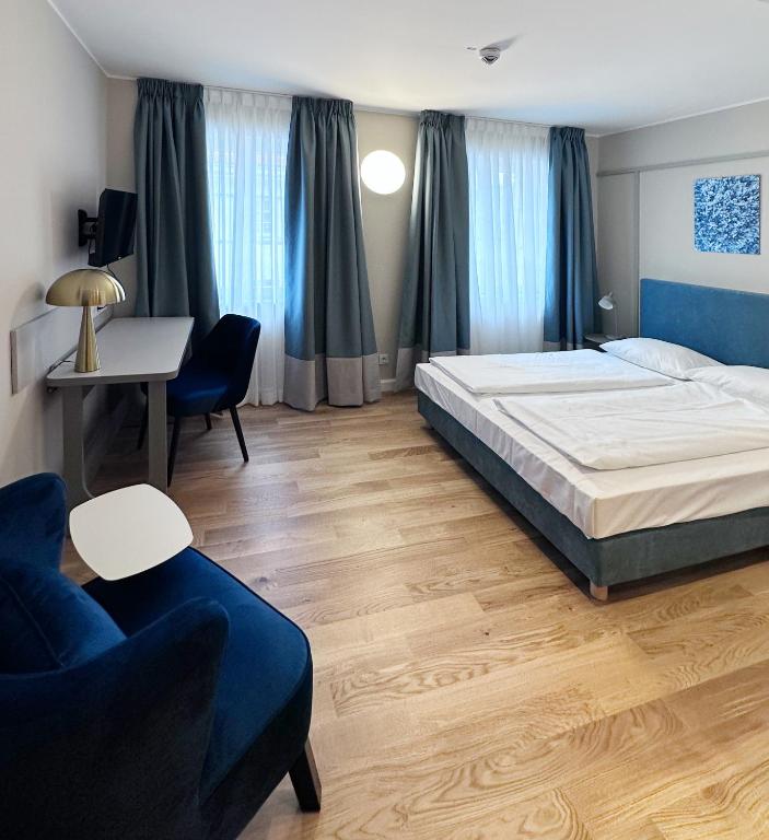 a bedroom with a bed and a desk and a couch at Townhouse Düsseldorf in Düsseldorf