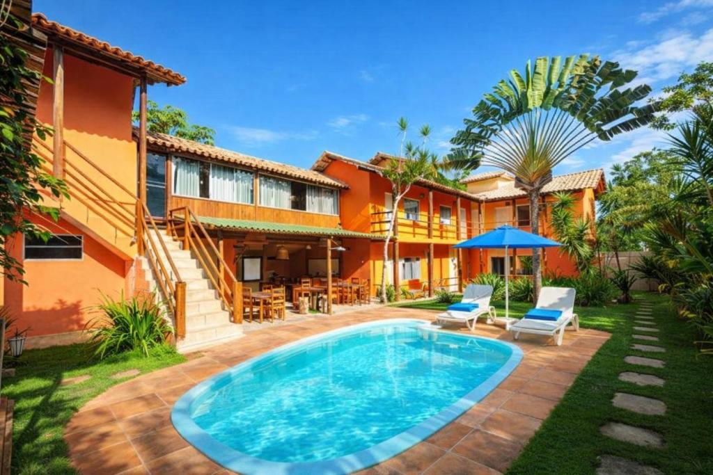 an image of a house with a swimming pool at Mandacaru Pousada Arraial D'Ajuda in Arraial d'Ajuda