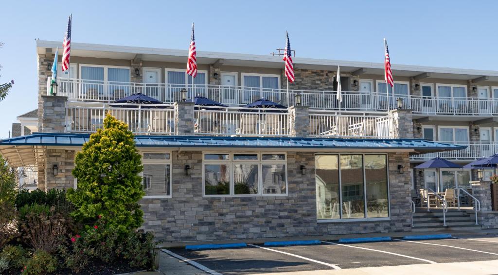 a building with american flags on top of it at Concord Suites in Avalon