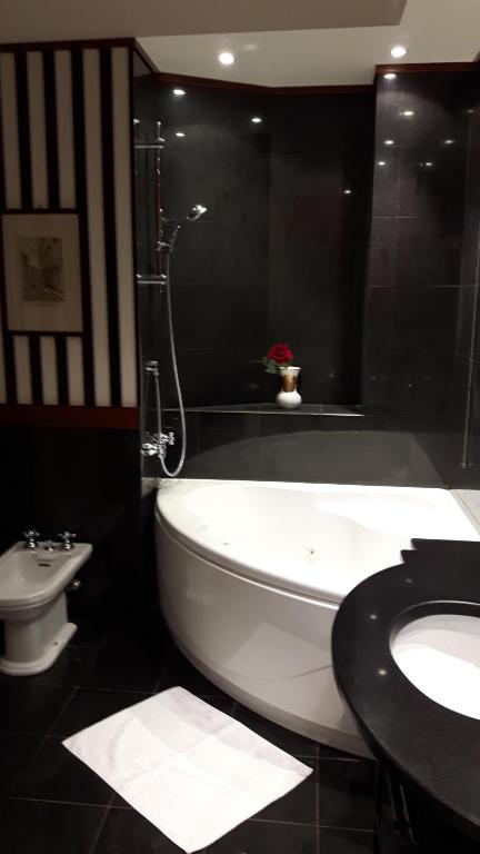 a bathroom with a tub and a sink and a toilet at Giulio Caesar in Rome