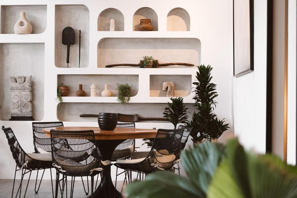 a dining room with a table and chairs at Casa Leone Villa Canggu by Summerhouse Bali in Canggu