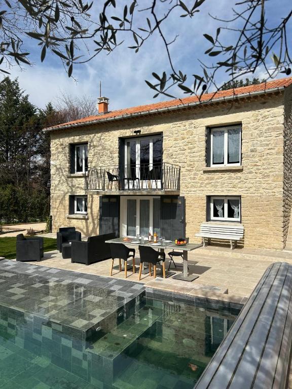 a house with a swimming pool in front of a house at Les Miracles du Ventoux in Malaucène
