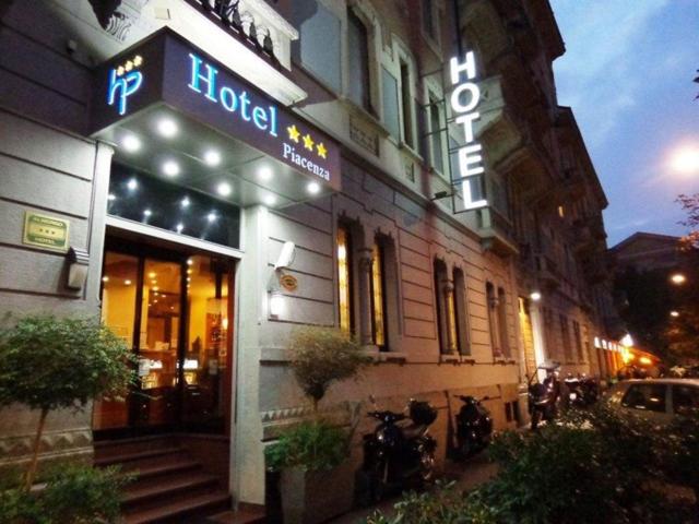 a hotel with a sign on the side of a building at Hotel Piacenza in Milan