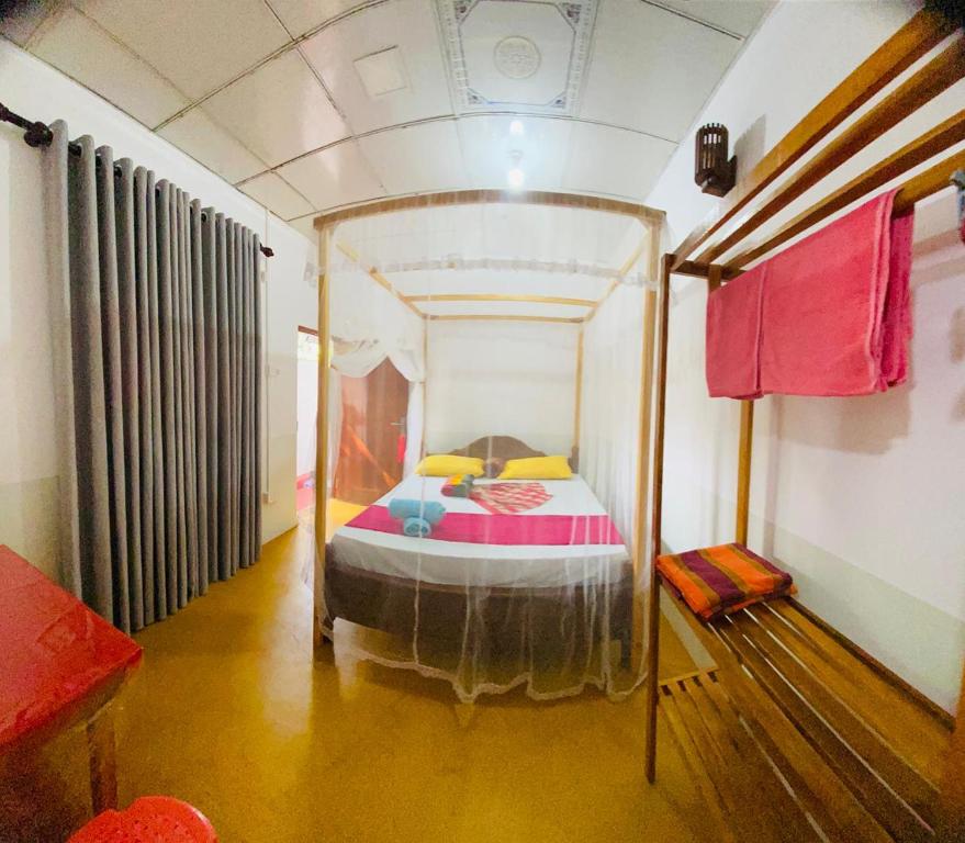 a bedroom with a canopy bed in a room at Dream Haven Mirissa in Mirissa