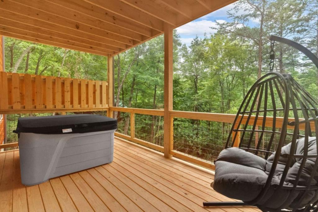 a porch with a hammock and a swing at Sneaky Bear in Sevierville