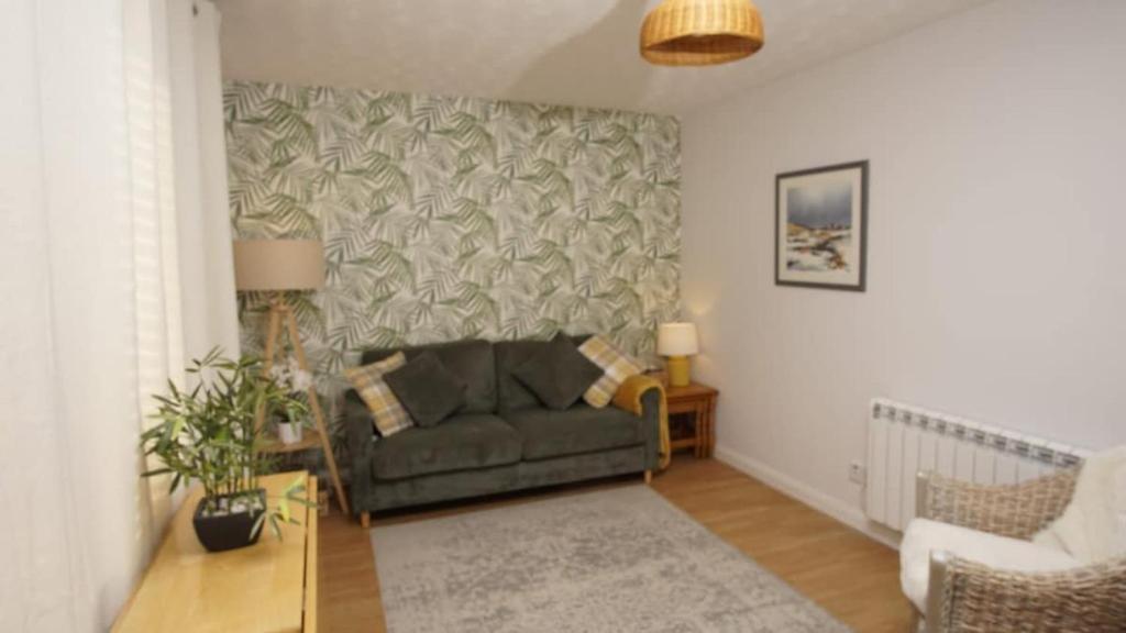 a living room with a couch and a table at Cosy flat in Inverness