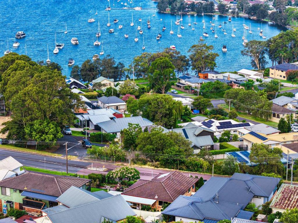 an aerial view of a town with boats in the water at Wangi Waters and Views in Wangi Wangi