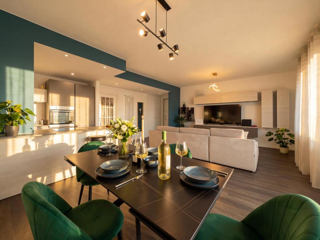 a dining room and living room with a table and chairs at Design Penthouse with Balcony - Iseo in Iseo