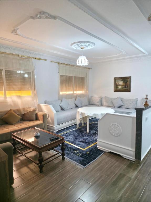 a living room with a couch and a table at إقامة الكرنيش in Nador