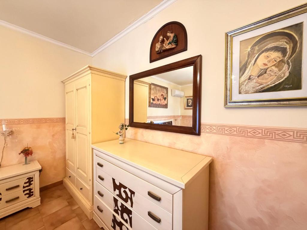 a bathroom with a dresser and a mirror on the wall at Art & Relax House in Gallipoli
