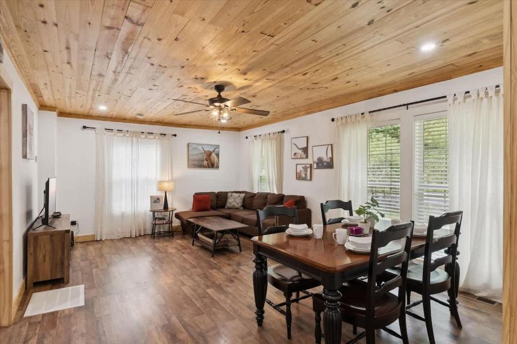 a living room with a table and a couch at Creekside Retreat by Beyond Expectations in Pigeon Forge
