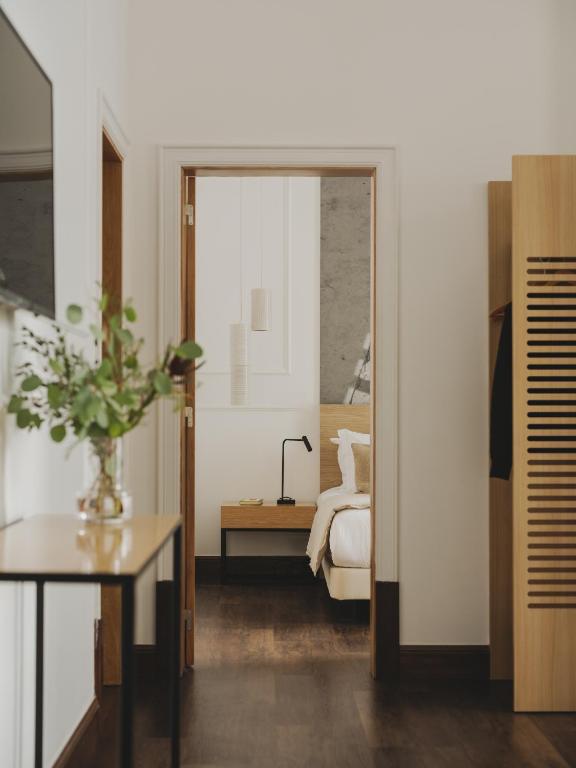 a bedroom with a bed and a table and a mirror at Casa Solayme Garrett in Lisbon
