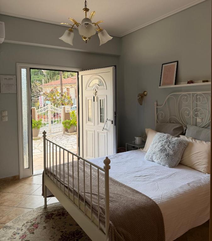 a bedroom with a bed and a ceiling fan at The Stay in Igoumenitsa