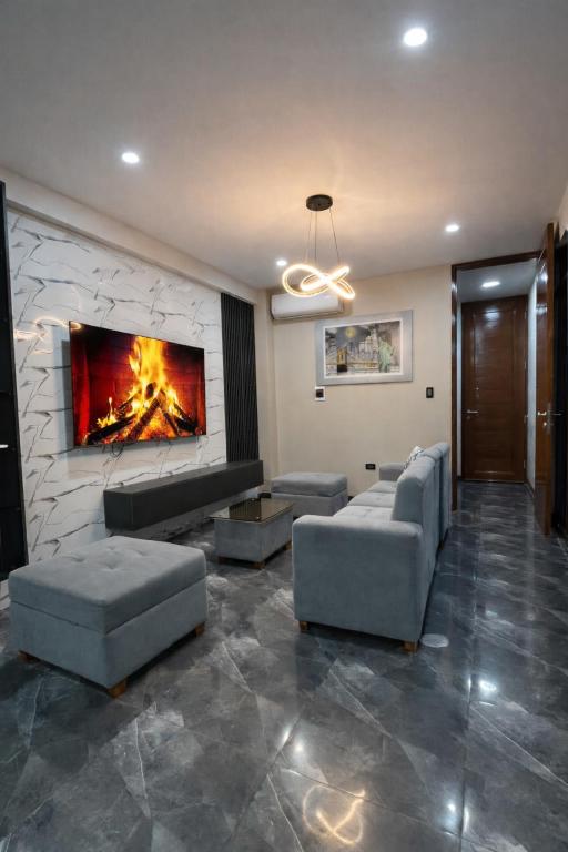 a living room with couches and a fireplace at Peruyork Arbnb - Sol de Pimentel in Chiclayo