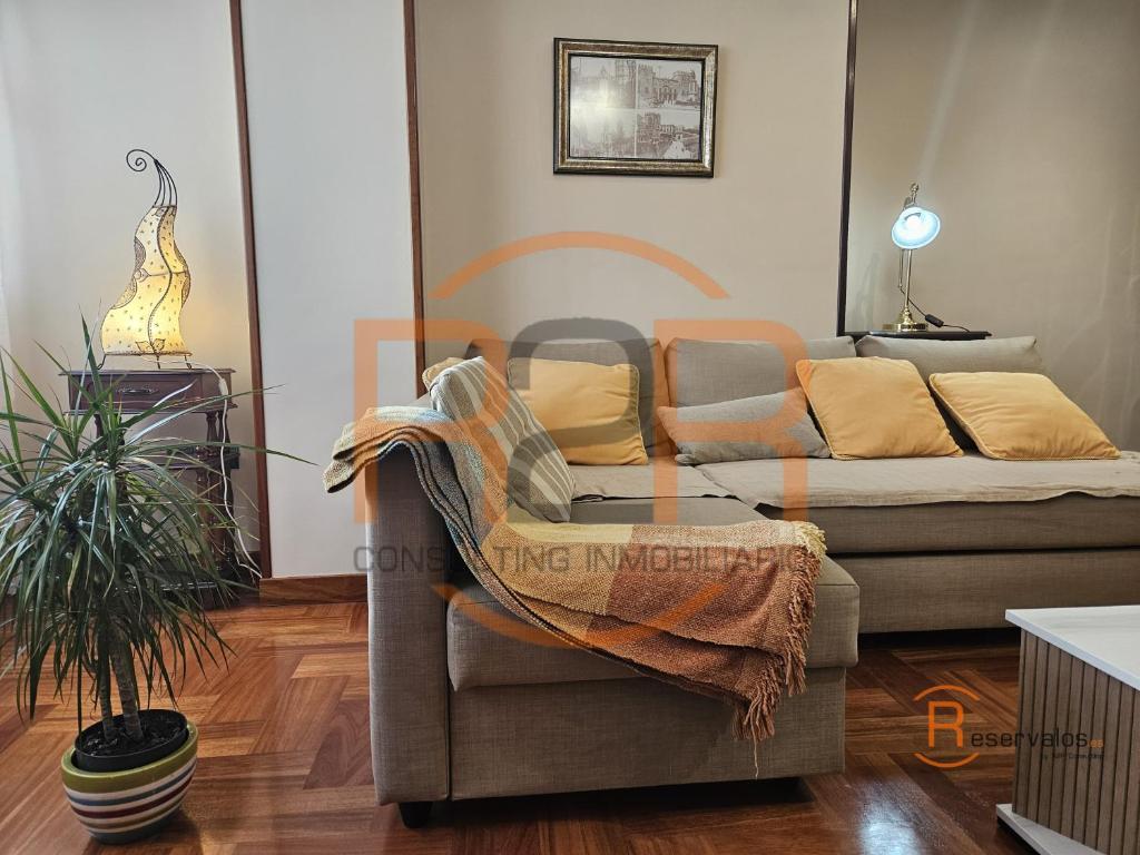 a living room with a couch and a chair at R2R - El Raitán - 1A122 in Gijón
