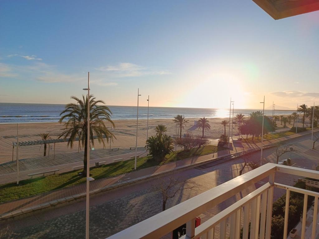 a balcony with a view of the beach and the ocean at Primera línea Playa Gandia in Gandía