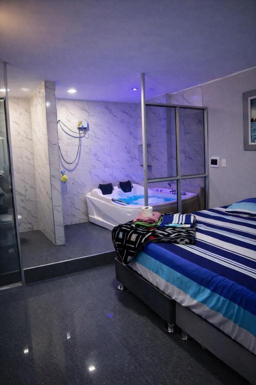 a room with two beds and a shower in it at Peruyork Arbnb - Calle España in Chiclayo