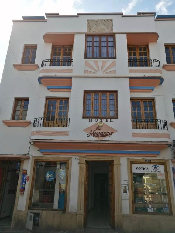 a white building with a sign on the front of it at HOTEL El MONARCA in Tunja
