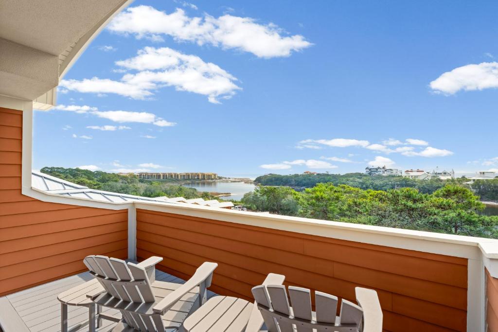 a balcony with two chairs and a large window at Sanctuary at Redfish 3119 by Newman-Dailey in Santa Rosa Beach