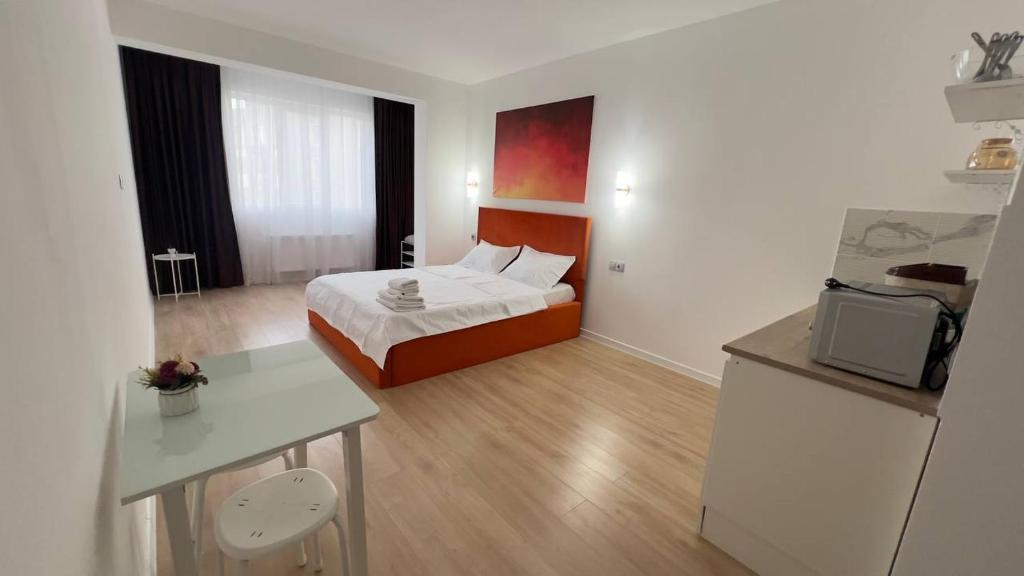 a hotel room with a bed and a kitchen at Aspan City Comfort 3 in Pokrovka