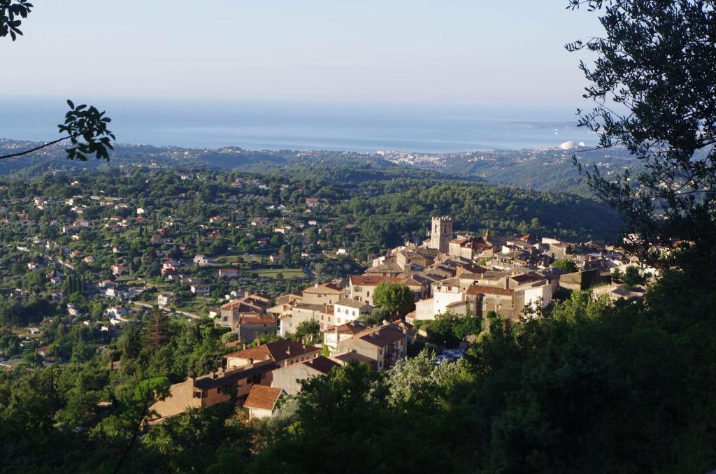 a town on a hill with houses and trees at Bed & Breakfast Les LILLAS in Saint-Jeannet