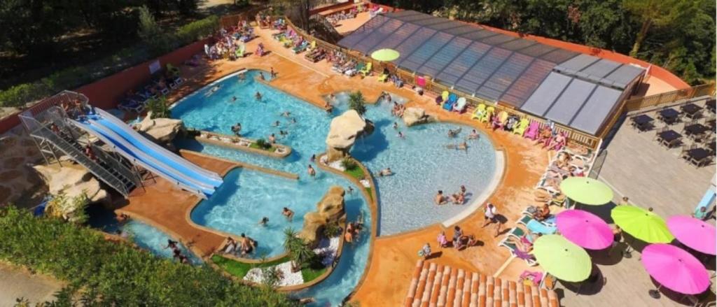 a large swimming pool at a water park at ZEcamping 4 étoiles familial avec piscine couverte in Laroque-des-Albères