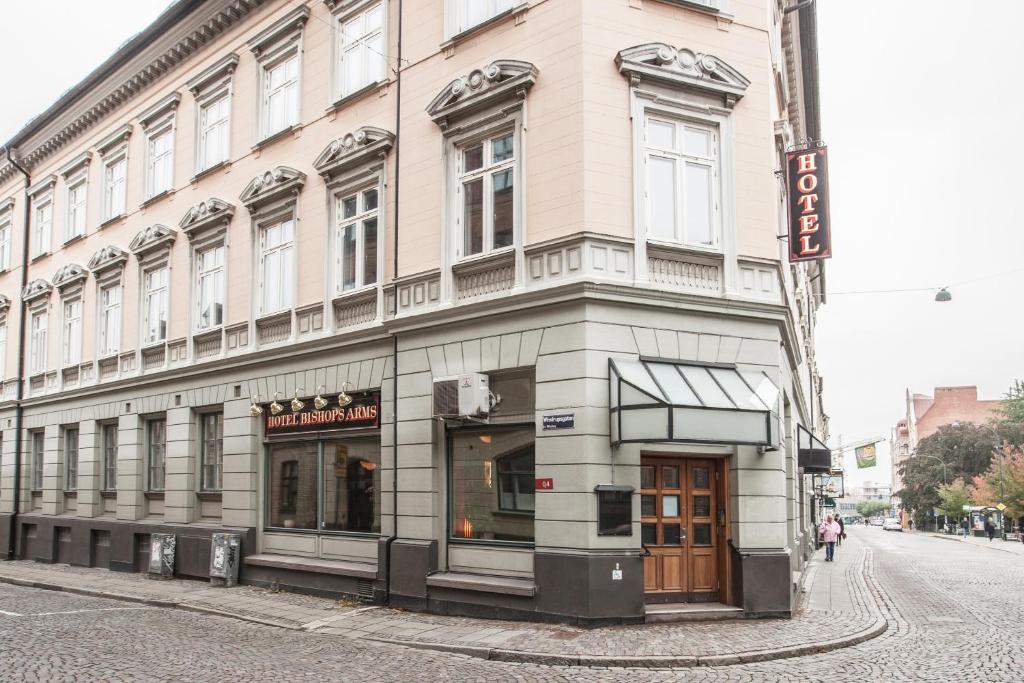 a large building on the corner of a street at Hotel Bishops Arms Lund in Lund