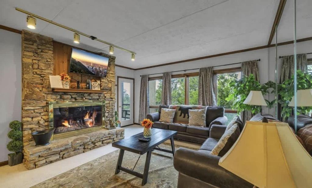 a living room with a couch and a fireplace at Misty Mountain Condo by Beyond Expectations- 3BR Retreat with Scenic Views, Sleeps 8 & Near Ober Mountain in Gatlinburg