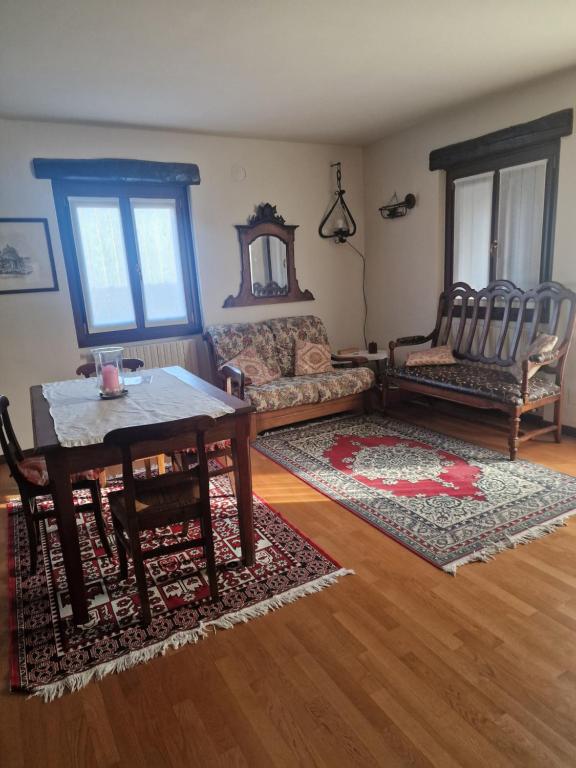 a living room with a table and chairs at Ginetta in Madonna del Sasso