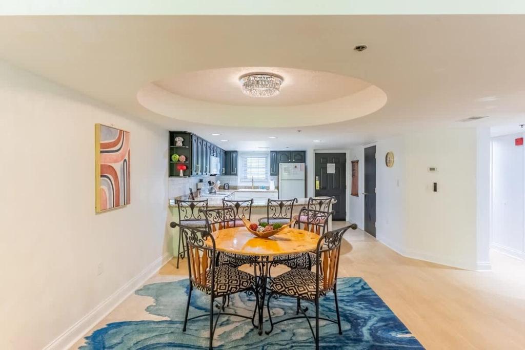 a kitchen and dining room with a table and chairs at Gatehouse Condo by Beyond Expectations w Views in Gatlinburg