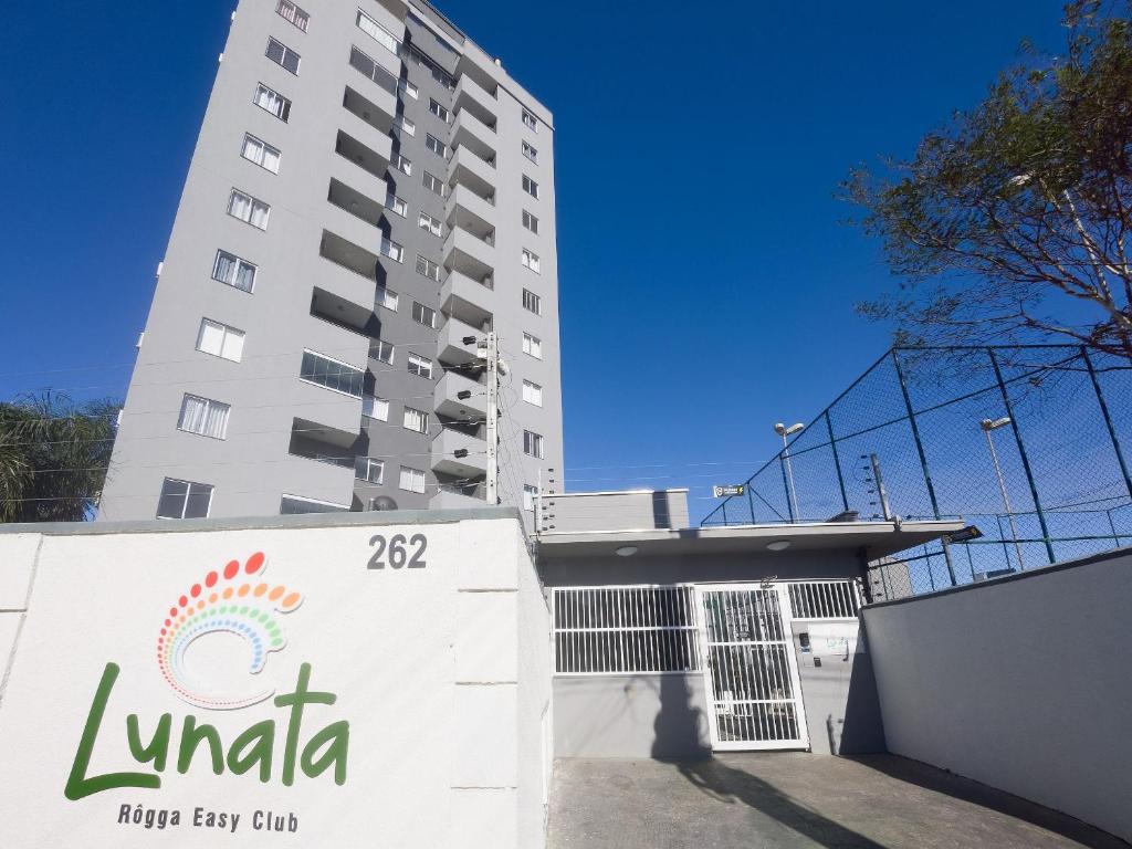 a building with a sign in front of it at Curta Praia do Quilombo - Lunata in Penha