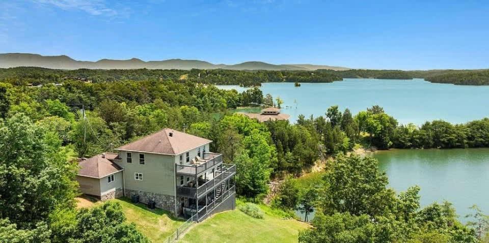 an aerial view of a house on a lake at Lighthouse Lookout by Beyond Expectations - Hot Tub & Lake Views in Sevierville