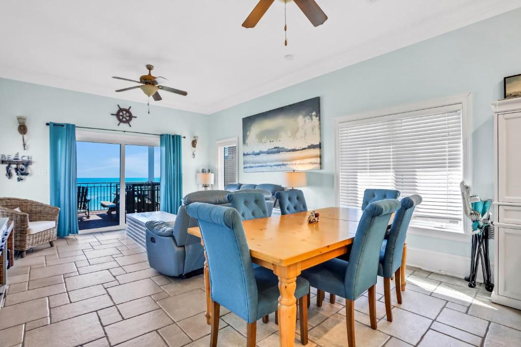a dining room with a table and chairs and the ocean at Beachfront home with pool elevator dog-friendly in St. George Island