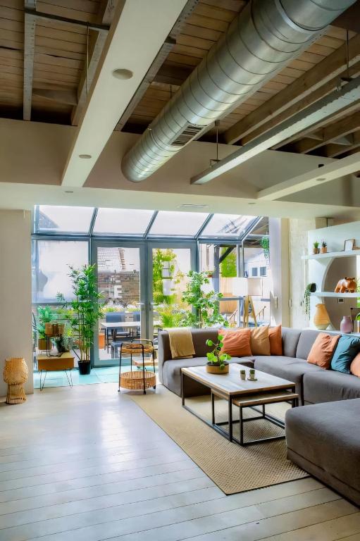 a living room with a couch and a table at City Loft I Fireplace I Free Parking I Garden Bath in Nieuwpoort