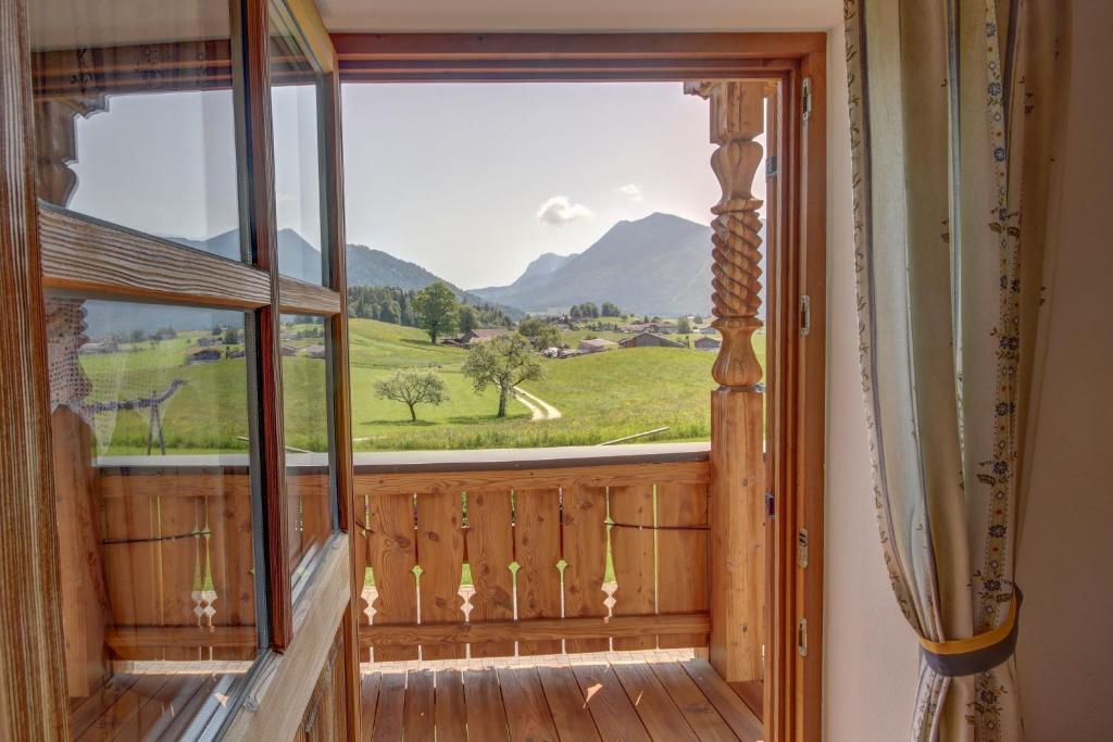 a window in a room with a view of a mountain at Wimmerhof - Chiemgau Karte in Inzell