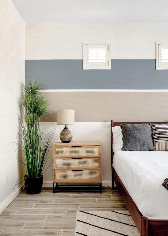 a bedroom with a blue and white striped wall at Sandcastle House Pool, Spa, Golf! in Queen Creek