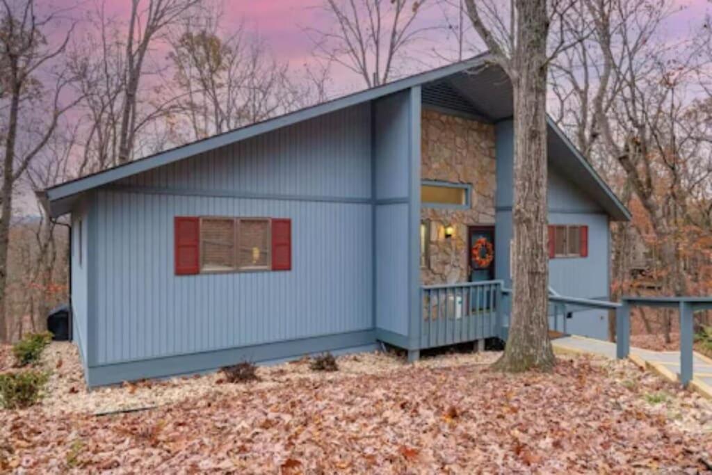 a blue house with a tree in front of it at Massanutten Chalet View & Fire Table Deck in McGaheysville