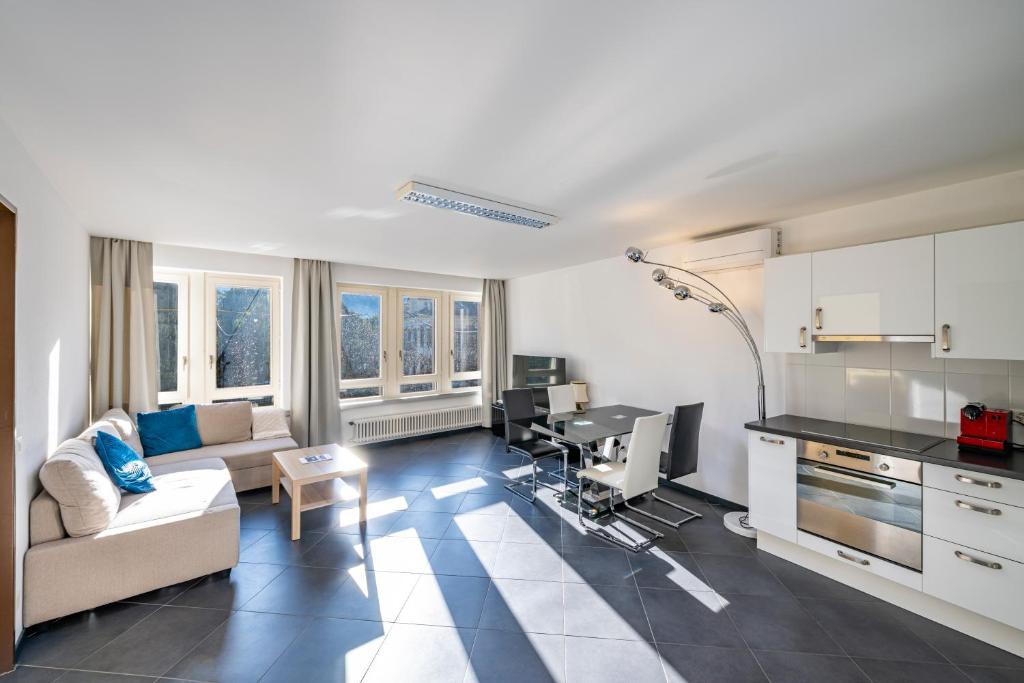 a living room with a couch and a desk at CENTRO Appartamento Ascona in Ascona