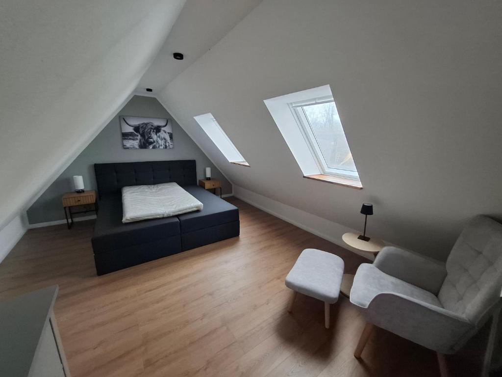 a room with a bed and a couch and a chair at Ferienwohnung Hof Dittmer in Bleckede