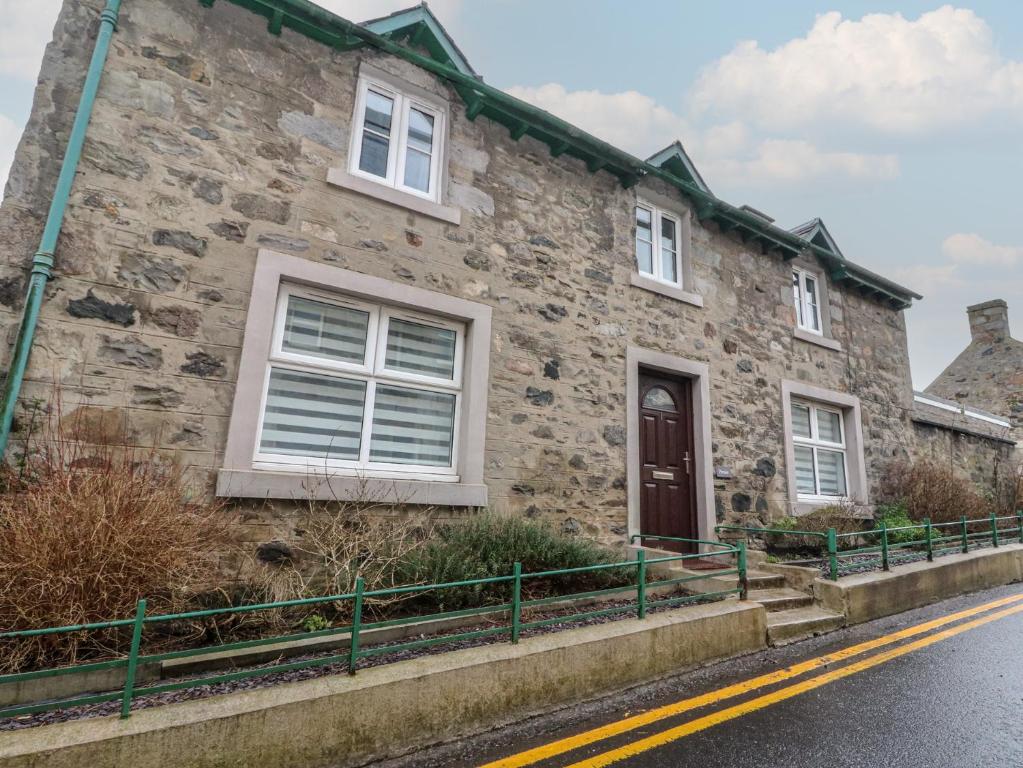 a stone house on the side of a street at Pirnies in Pitlochry