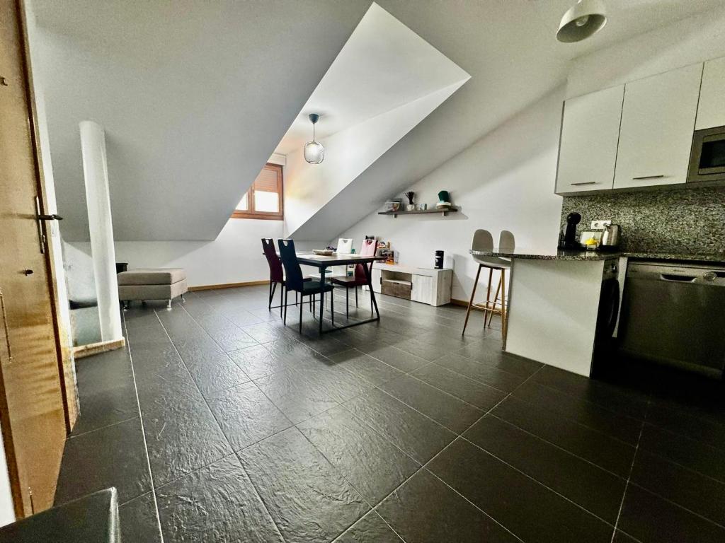 a kitchen with a table and chairs in a room at Aldea Bricia 12 in Posada de Llanes
